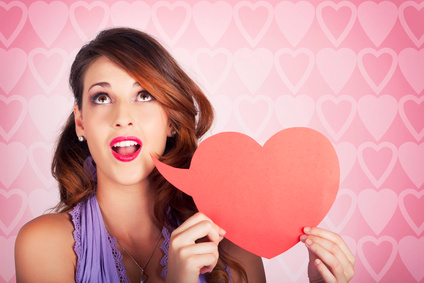 Romantic Woman Shouting Out Message Of Love Through Blank Heart Shaped Speech Bubble